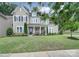 Charming home with meticulously maintained lawn, covered front porch, neutral siding, and beautifully landscaped flower beds at 11216 Preservation Ln, Charlotte, NC 28278