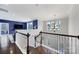 Upstairs foyer with a view of the main level, chandelier, tv area, and hardwood floors at 11216 Preservation Ln, Charlotte, NC 28278