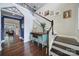 Elegant foyer showcases hardwood floors, a wooden staircase, designer console table, and stylish blue accent wall at 11216 Preservation Ln, Charlotte, NC 28278