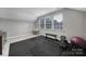 Spacious home gym with exercise equipment and rubber mat flooring, offering a dedicated space for fitness and wellness at 11216 Preservation Ln, Charlotte, NC 28278