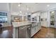 Kitchen island with stainless steel dishwasher and sink; stainless steel appliances and pendant lighting fixtures at 11216 Preservation Ln, Charlotte, NC 28278