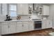 Updated kitchen features white cabinets, stainless appliances, granite counters, and modern finishes at 11216 Preservation Ln, Charlotte, NC 28278