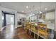 Bright kitchen boasts stainless appliances, granite counters, an island with bar seating, and hardwood flooring at 11216 Preservation Ln, Charlotte, NC 28278