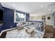 Living room with plush sofa, bright blue accent wall, and hardwood floors at 11216 Preservation Ln, Charlotte, NC 28278