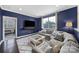 Comfortable living room featuring a large sectional sofa, decorative rug, and a mounted TV for relaxing evenings at 11216 Preservation Ln, Charlotte, NC 28278