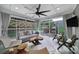Bright sunroom features an outdoor view, modern furniture, unique wood decor, and ample natural light at 11216 Preservation Ln, Charlotte, NC 28278