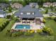 Aerial view showcasing a large backyard with a swimming pool, patio seating and lush landscaping at 1152 Grand Oak Dr, Waxhaw, NC 28173