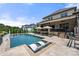 Stunning backyard oasis featuring a pool, tanning chairs, lounge areas and outdoor dining at 1152 Grand Oak Dr, Waxhaw, NC 28173