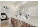 Dual sink bathroom vanity featuring modern fixtures and a spacious counter, adjacent to the bedroom at 1152 Grand Oak Dr, Waxhaw, NC 28173