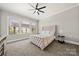 Comfortable bedroom with neutral tones, large windows and ceiling fan at 1152 Grand Oak Dr, Waxhaw, NC 28173