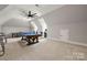 Spacious bonus room with pool table, ping pong table, arcade games and a modern ceiling fan at 1152 Grand Oak Dr, Waxhaw, NC 28173