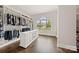 Large walk-in closet featuring custom shelving, drawers, and natural light from a nearby window at 1152 Grand Oak Dr, Waxhaw, NC 28173