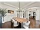 Airy dining area with hardwood floors, stylish lighting, and views of the home's interior at 1152 Grand Oak Dr, Waxhaw, NC 28173