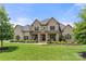 Impressive two-story brick home with a manicured lawn and covered front porch at 1152 Grand Oak Dr, Waxhaw, NC 28173