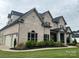 Spacious home with a charming brick exterior, attached garage, and beautifully landscaped yard, offering comfort and style at 1152 Grand Oak Dr, Waxhaw, NC 28173
