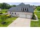 Spacious three car garage and side yard with basketball hoop, showcasing the home's exterior and recreational space at 1152 Grand Oak Dr, Waxhaw, NC 28173