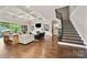 Elegant living room with a coffered ceiling, fireplace, and access to outdoor patio at 1152 Grand Oak Dr, Waxhaw, NC 28173