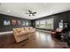Cozy living room with movie-themed decor, comfortable seating, and natural light highlighting the wood floors at 1152 Grand Oak Dr, Waxhaw, NC 28173