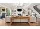 Bright living room with fireplace, built-in shelving, hardwood floors, and access to the outdoor area at 1152 Grand Oak Dr, Waxhaw, NC 28173