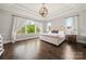 Spacious primary bedroom with tray ceiling, hardwood floors, and plenty of natural light at 1152 Grand Oak Dr, Waxhaw, NC 28173