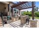 Outdoor kitchen on a brick patio featuring a built in grill and an outdoor bar at 1152 Grand Oak Dr, Waxhaw, NC 28173