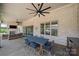 Covered patio with a brick wall, and a dining table next to a fireplace and seating at 1152 Grand Oak Dr, Waxhaw, NC 28173