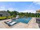 Backyard swimming pool featuring lounge chairs inside the pool and landscaping at 1152 Grand Oak Dr, Waxhaw, NC 28173