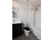 Clean bathroom with black vanity, white walls, shower over tub at 116 Crownpiece St, Troutman, NC 28166