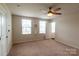 Spacious bedroom with neutral carpet, ceiling fan, and a bright window at 116 Crownpiece St, Troutman, NC 28166