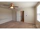 Bedroom with window, carpeted floor, and open doorway at 116 Crownpiece St, Troutman, NC 28166