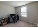 Bedroom with carpeted floor, a bright window, and versatile space for relaxation or work at 116 Crownpiece St, Troutman, NC 28166