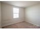 Cozy bedroom with window and carpeting, ideal for rest and relaxation at 116 Crownpiece St, Troutman, NC 28166