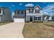 Two-story home with blue siding, white garage door, and well-maintained front lawn at 116 Crownpiece St, Troutman, NC 28166