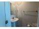 Compact half bath with pedestal sink and a towel rack at 116 Crownpiece St, Troutman, NC 28166