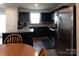 Modern kitchen features black cabinets, stainless steel appliances, and granite countertops at 116 Crownpiece St, Troutman, NC 28166