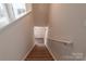 Carpeted staircase with handrail leading to the upper level of the home at 116 Crownpiece St, Troutman, NC 28166