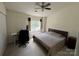 Bright bedroom featuring a ceiling fan, large window and a cozy reading nook by the window at 12238 Paperbark Cir, Charlotte, NC 28277