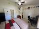 Well-lit bedroom boasts a ceiling fan, double closets, and a connected bathroom at 12238 Paperbark Cir, Charlotte, NC 28277