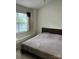 Neutral bedroom with a window and sleek dark wood headboard at 12238 Paperbark Cir, Charlotte, NC 28277