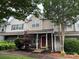 Traditional townhome showcasing a brick front, cozy porch, and tidy landscaping enhancing curb appeal at 12238 Paperbark Cir, Charlotte, NC 28277