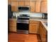 Modern kitchen features stainless steel appliances, granite countertops, and wood cabinets at 12238 Paperbark Cir, Charlotte, NC 28277
