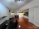 Spacious living room features wood floors, lots of sunlight, and neutral paint for easy customization at 12238 Paperbark Cir, Charlotte, NC 28277