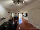 Spacious living room features wood floors, lots of sunlight, and neutral paint for easy customization at 12238 Paperbark Cir, Charlotte, NC 28277