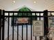 Close-up view of the gated pool entrance with posted safety rules and emergency contact information at 12238 Paperbark Cir, Charlotte, NC 28277