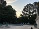 Community pool featuring plenty of lounge chairs and bordered by mature trees at 12238 Paperbark Cir, Charlotte, NC 28277