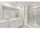 Bright bathroom featuring double vanity sinks, a large mirror, and a glass-enclosed shower at 124 Utility Ln # B, Mooresville, NC 28117