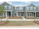 Modern townhome with blue siding, white trim, and well-manicured landscaping provides excellent curb appeal at 124 Utility Ln # B, Mooresville, NC 28117