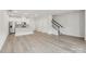 Open-concept living space featuring hardwood floors, a modern kitchen, and staircase at 124 Utility Ln # B, Mooresville, NC 28117