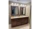 Bathroom featuring a double sink vanity with granite countertop, two mirrors, and tile flooring at 12517 Pine Terrace Ct, Charlotte, NC 28273