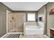 Relaxing bathroom with a tub, separate tiled shower, and neutral-toned walls for a soothing atmosphere at 12517 Pine Terrace Ct, Charlotte, NC 28273